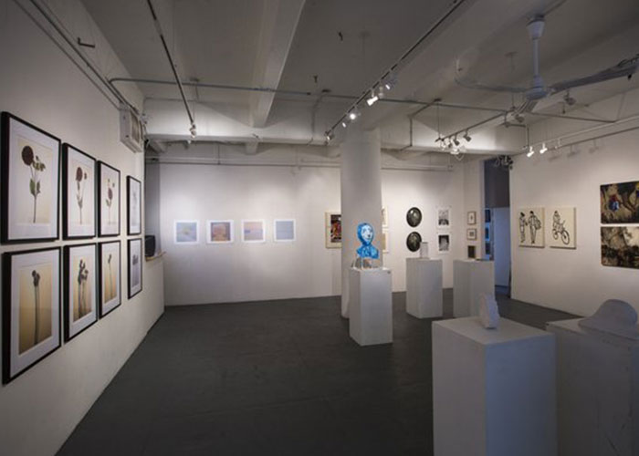 Photo of the gallery from inside with artwork on display.